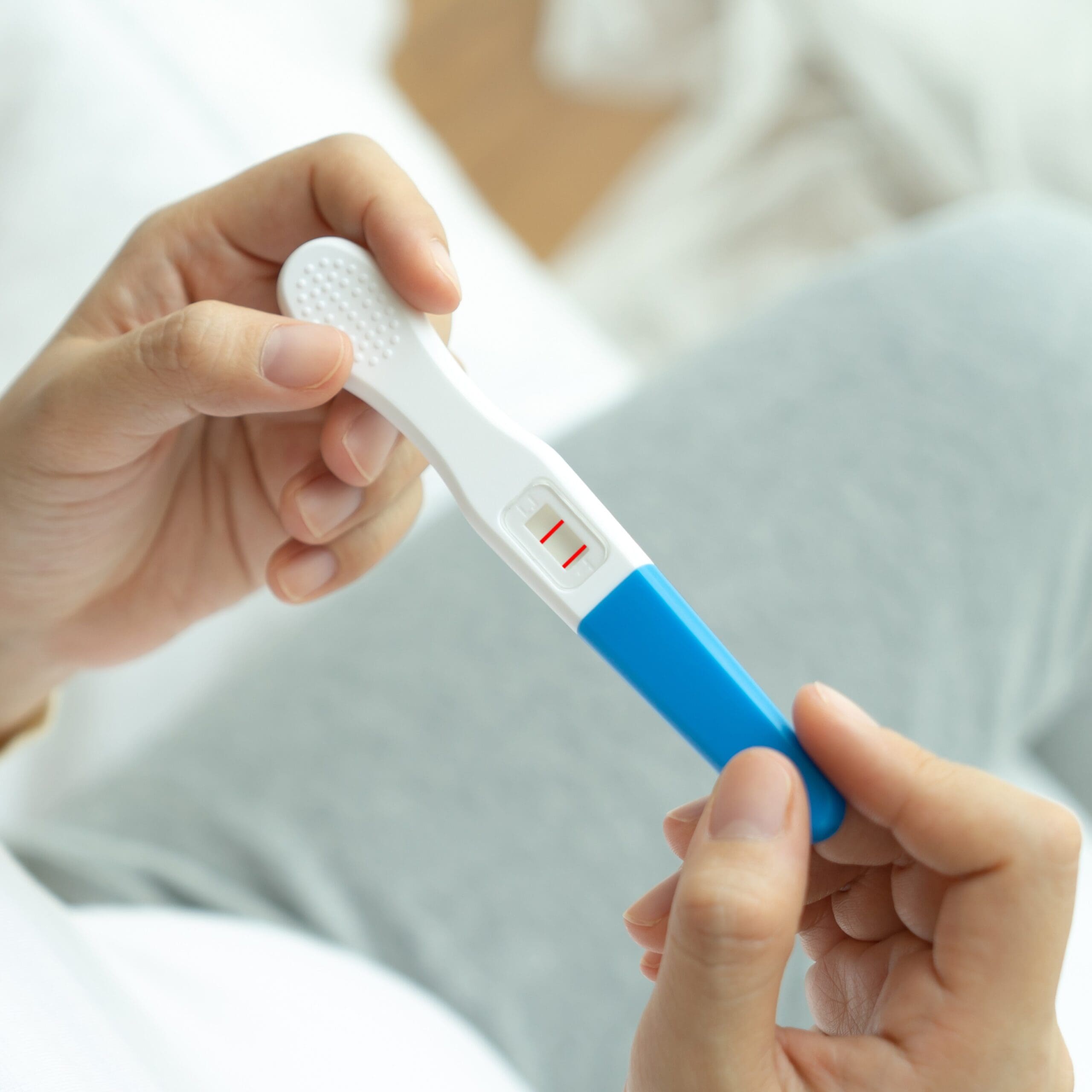 Woman holding a pregnancy test